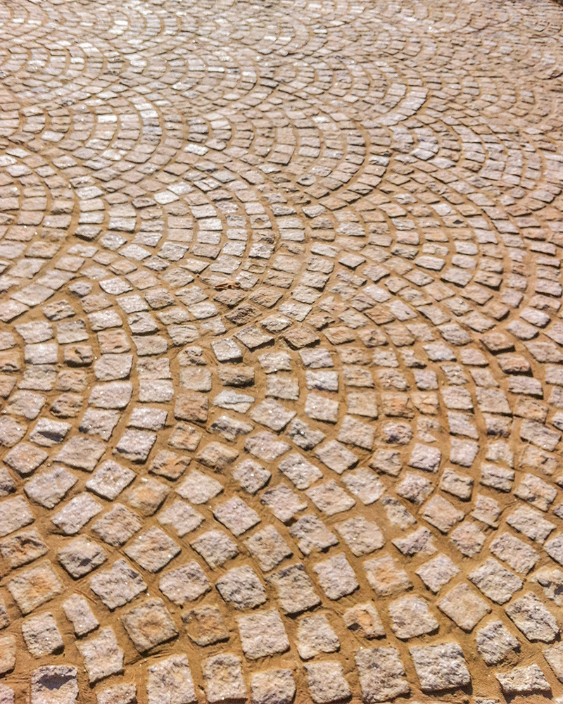 4in x 4in Buff Granite Cobblestones Laid In A Fan Pattern