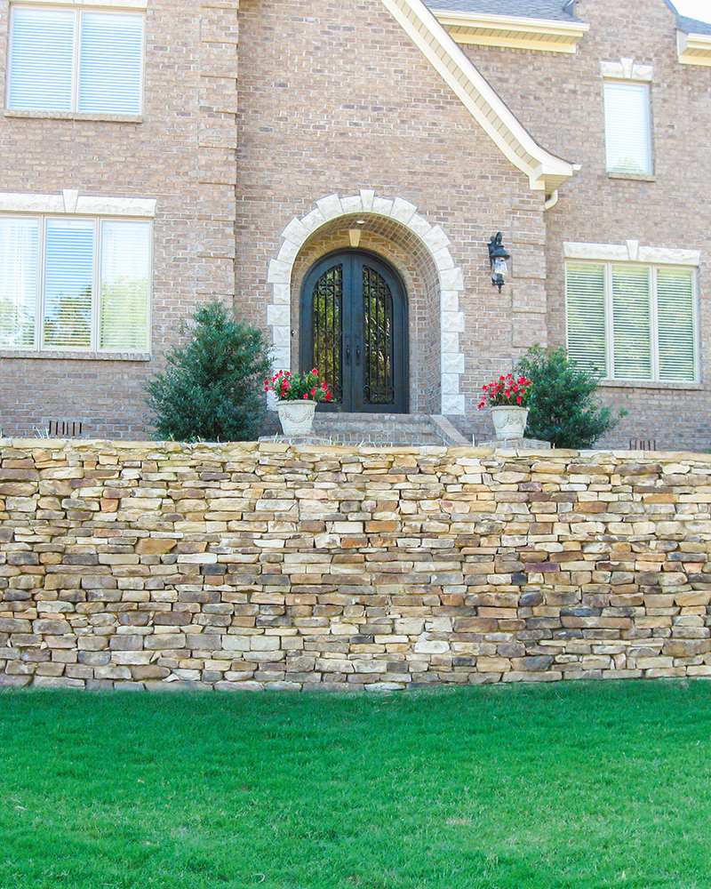 Dry Stacked Medium Longstack Moss Rock (Fieldstone) Retaining Wall